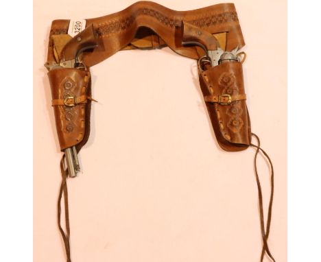A pair of Navy Colt 1851 cap-firing revolvers marked BKA 98, with a well-tooled brown leather belt and dual holster. P&amp;P 