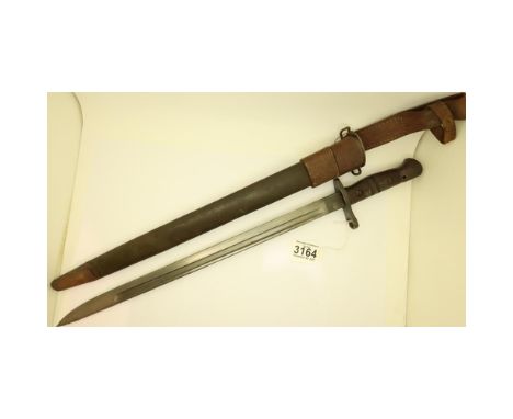 An American 1918 model Remington bayonet and leather scabbard with leather frog, riccaso marked US with eagle head, blade L: 