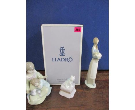 A Lladro figure Little Sister and a Lladro figural group, together with a Lladro Scottie dog perched on a pouffe 