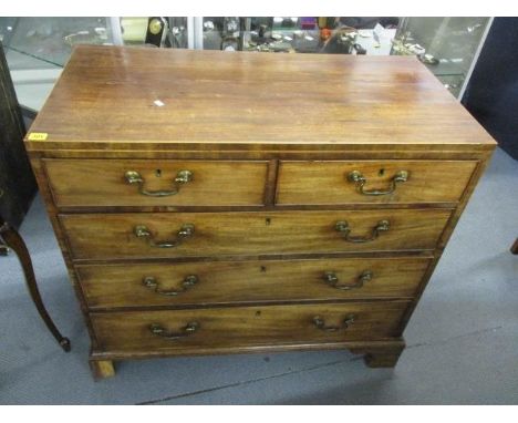 A George III straight fronted chest of two short and three long drawers with swan neck drop handles and ogee bracket feet, 36