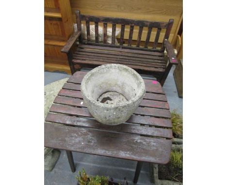 A teak garden bench and a matching garden table 