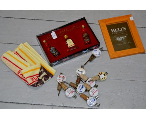 COLLECTION OF BELL'S WARE INCLUDING A BOXED SET OF MINIATURES, BAR TOWEL, FRAMED MIRROR & 9 VARIOUS CERAMIC POURERS     