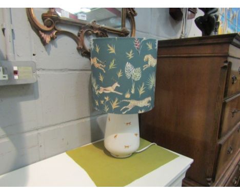 A ceramic table lamp with cheetah motifs &amp; similar shade. 