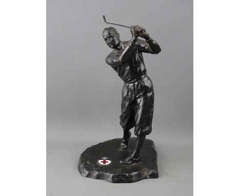 A VINTAGE CAST METAL FIGURE OF A GOLFER, the base set with an oval enamel plaque showing the emblems for the Red Cross and St