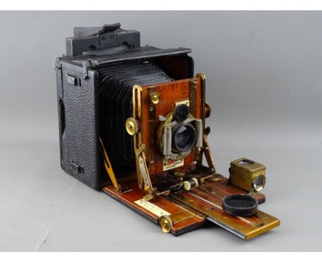A SANDERSON HAND PLATE CAMERA, mahogany and brass with black square bellows