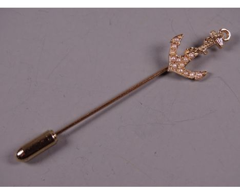 AN UNMARKED GOLD STICK PIN with seed pearl encrusted anchor, 2.2 grms