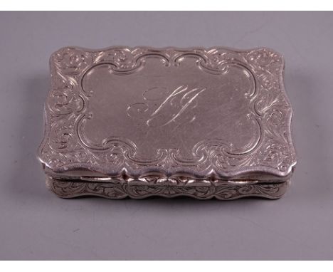 AN OBLONG SILVER SNUFF BOX with shaped lid having scrolled border decoration, 2 troy ozs, Birmingham 1849 by Nathaniel Mills