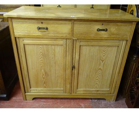 A VINTAGE LIGHT OAK TWO DRAWER, TWO DOOR CABINET, 107 cms high, 122 cms wide, 56.5 cms deep