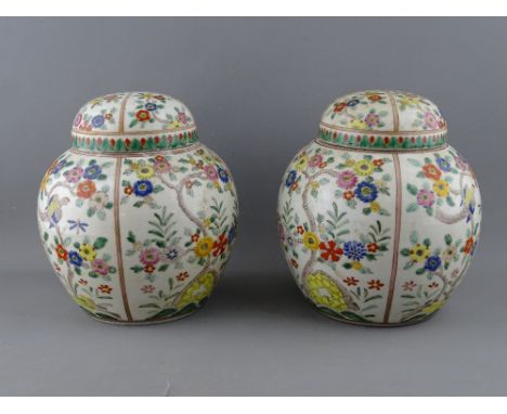 A PAIR OF ORIENTAL GINGER JARS & COVERS with enamel decorated panels of birds and flowers, single iron red seal mark to the l