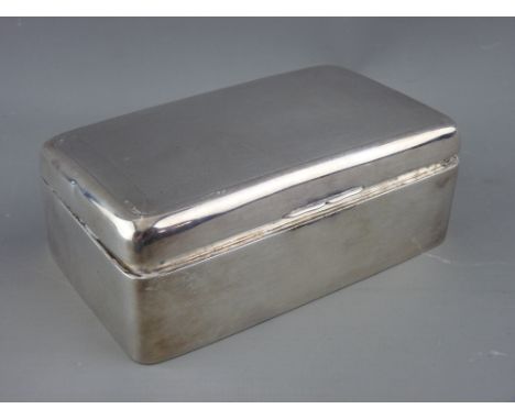 A RECTANGULAR SILVER CIGARETTE BOX, the lid with engine turned decoration, 13.5 cms long, hallmarks rubbed but possibly Birmi