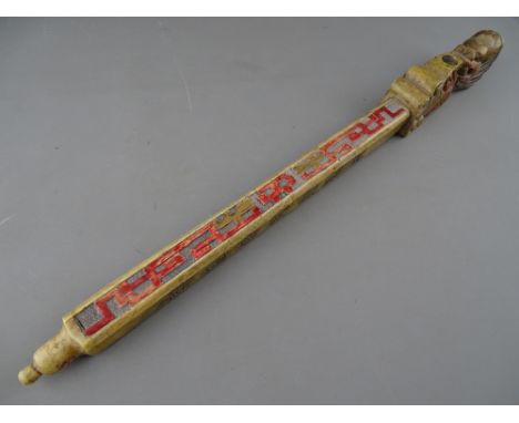 A CHINESE CARVED SOAPSTONE OPIUM OR TOKE PIPE with stained colour highlighting and seal script decoration, 48.5 cms long