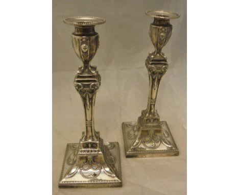 A pair of Edwardian silver candlesticks in the Egypto Classical taste (by R Hodd & Son London 1909) CONDITION REPORTS Candles