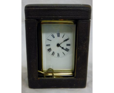 A brass carriage clock with Roman numerals to the enamel dial, housed in a leather case CONDITION REPORTS Unable to state whe
