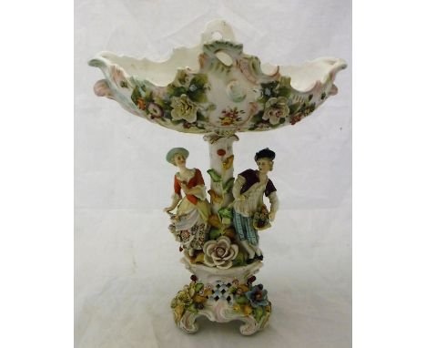 A late 19th Century Sitzendorf table centre with shaped bowl and floral encrusted decoration on a figural decorated pedestal 