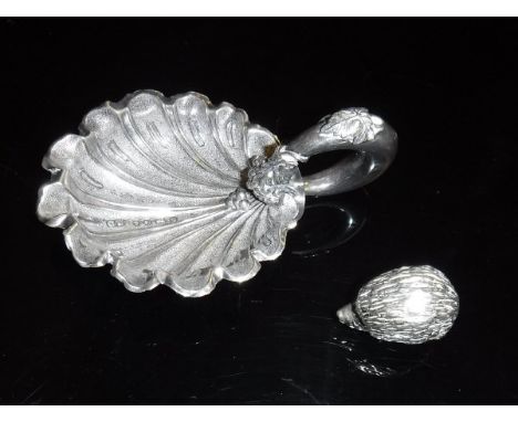A Victorian silver caddy spoon in the form of a shell with grape and vine decorated loop handle (by George Unite Birmingham 1