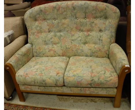 A Cintique beech framed two seat sofa with floral upholstery and a G Plan brown leather upholstered two-seat sofa