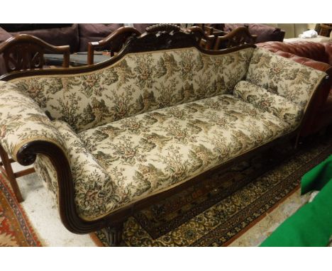 A William IV mahogany framed scroll arm sofa with shell carved and shaped top rail, carved scroll arms, raised on reeded supp