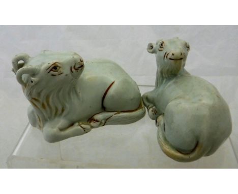 Two Chinese pale celadon glazed figures of recumbent goats with oxide red highlighting, un-marked CONDITION REPORTS To both g