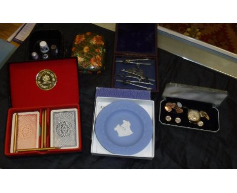 A box containing a pair of 9 carat gold cufflinks, a further cased set of mother of pearl and gold plated cufflinks and match