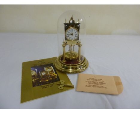 A Schatz brass skeleton clock in glass dome to include key and original manual