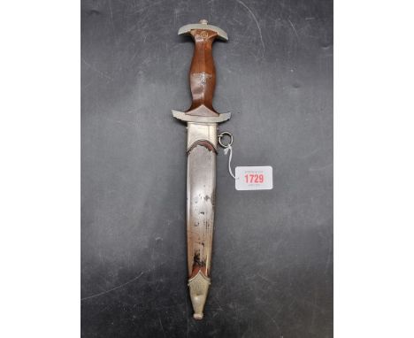 A German Third Reich SA dagger and sheath, the engraved 22cm blade stamped 'RZM M7/33 1940'.