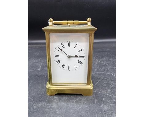 An antique brass carriage clock, with push button repeat and gong strike, height including handle 18cm.&nbsp; 
