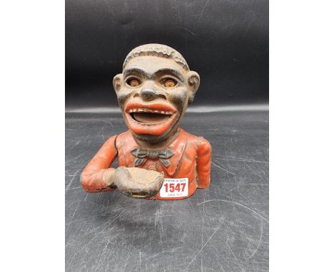 An antique cast iron 'Jolly N.... Bank', 16.5cm high.   These items are listed on the basis they are illustrative of by a gon