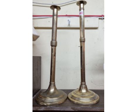 Two similar large 19th century brass ejecting candlestick,&nbsp;largest 50cm high, (one s.d.). (2) 