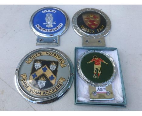 An enamel and chrome plated car badge depicting a footballer, probably 1950s and three others.