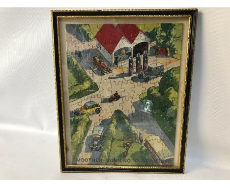 A Redline Motor Spirit jigsaw depicting a garage scene at a road junction, framed and glazed, 9 x 11 1/4".