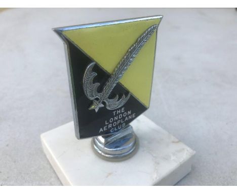 A London Aeroplane Club enamel badge mounted with a fern and star motif, display base mounted.