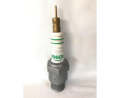 A Bosch plastic spark plug shaped decanter for topping up fluid etc. 14" high.