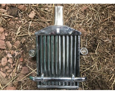A decanter in the form of a Rolls-Royce radiator grille.