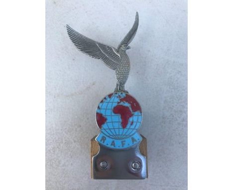 A part enamel badge depicting the globe, RAFA surmounted by a winged bird of prey. 