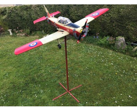 A scale model of a Chipmonk two seater aeroplane on a metal display stand.