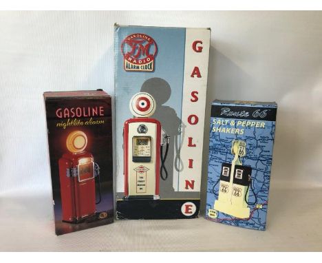A boxed model petrol pump, another in the form of an alarm clock and a boxed salt and pepper shaker formed by a pair of pumps