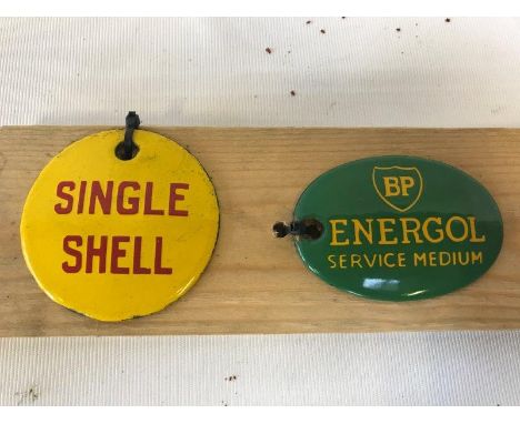 A Single Shell circular enamel tag, probably original, and an oval BP Energol enamel tag, probably reproduction.
