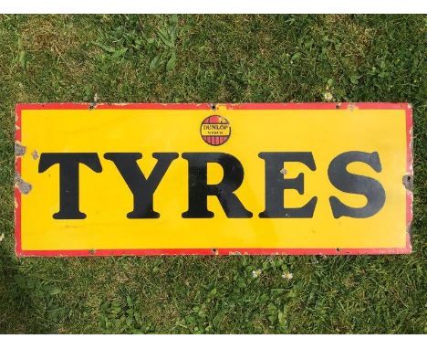 A Dunlop Stock Tyres rectangular enamel sign, 30 x 11 1/2".