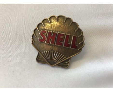 A Shell part enamel brass cap badge.