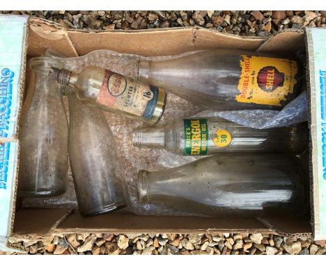 A Shell SAE 30 double Shell glass oil bottle, an Esso lighter fuel bottle and four others. 