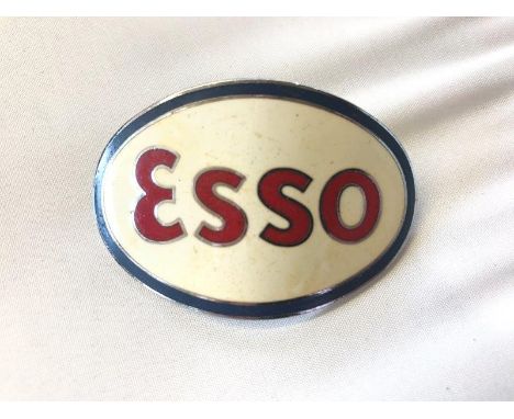 An Esso enamel cap badge. 