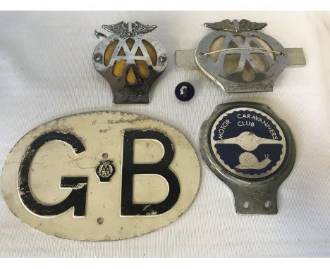 An AA GB oval plate, three car badges and an enamel lapel badge.