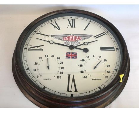 A decorative showroom wall clock with Jaguar decal and additional gauges to the dial for humidity and temperature.