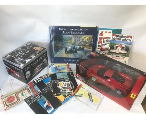 A boxed scale model of a Ferrari, a single volume titled 'The Automotive Art of Alan Fearnley' and various race programmes et