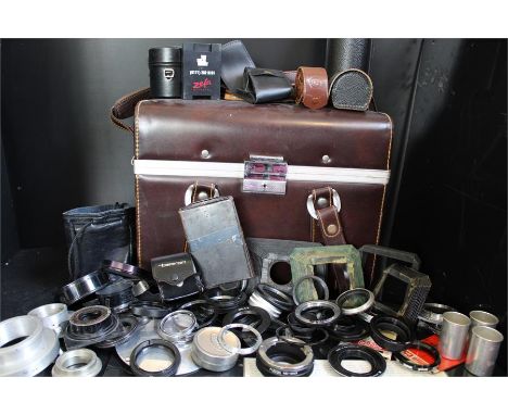 A Large Quantity of Camera Accessories in a rigid case including lens cases, HOYA filter case, Bellows adapters, Fotga MD-M4/