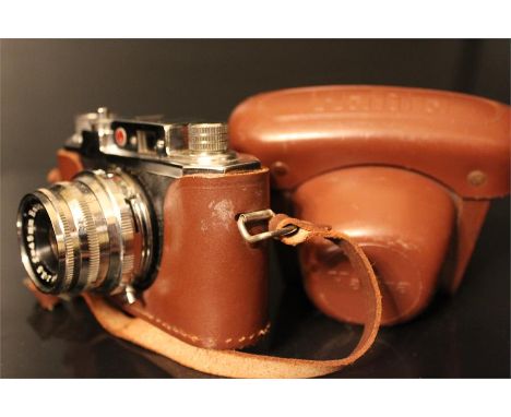 A Halina 35X camera with f=45mm 1:3.5 lens with case