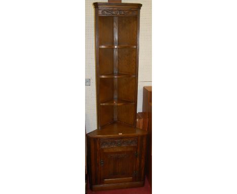 A contemporary Old Charm moulded oak free standing corner shelf, having linenfold panelled lower cupboard door