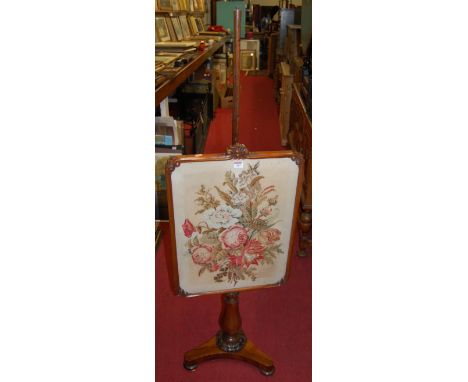 An early Victorian rosewood pedestal pole screen, having a large floral tapestry inset adjustable panel, on triform base, hei