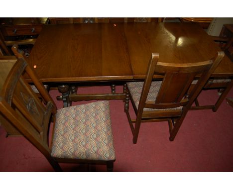 A contemporary Old Charm oak dining suite, comprising; extending dining table with pull-out action and two extra drop-in leav