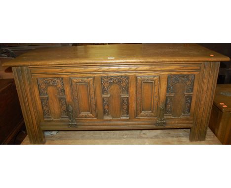 A contemporary moulded oak hinge top blanket box, having a fall-front panel, width 114cm
